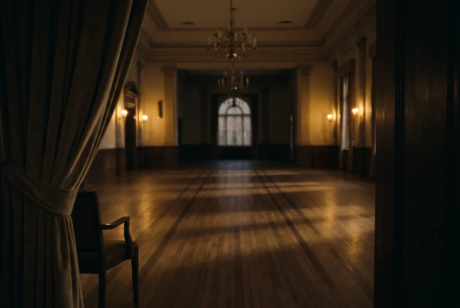 An elegant, empty event hall at dusk, lit with warm rim light and long cinematic shadows.